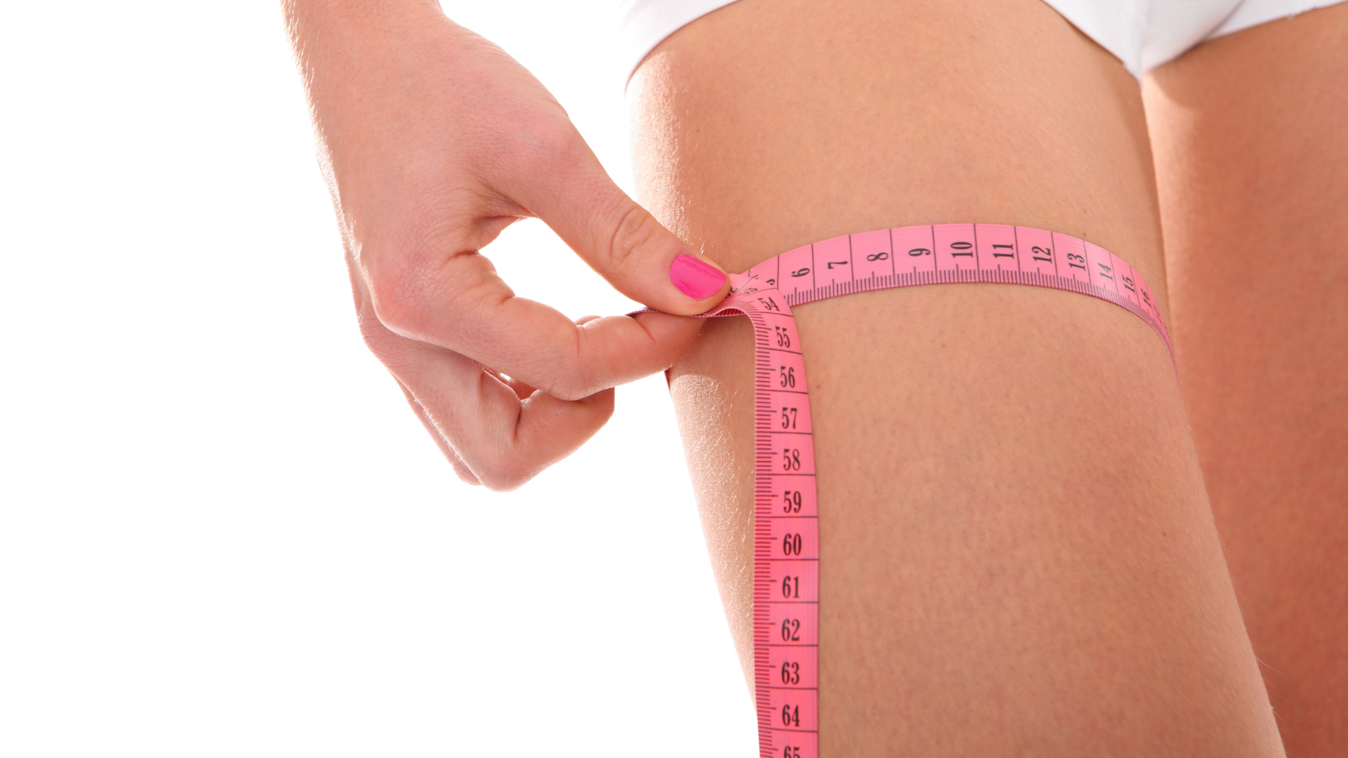 A woman holding a measuring tape around her legs | Physician's Institute